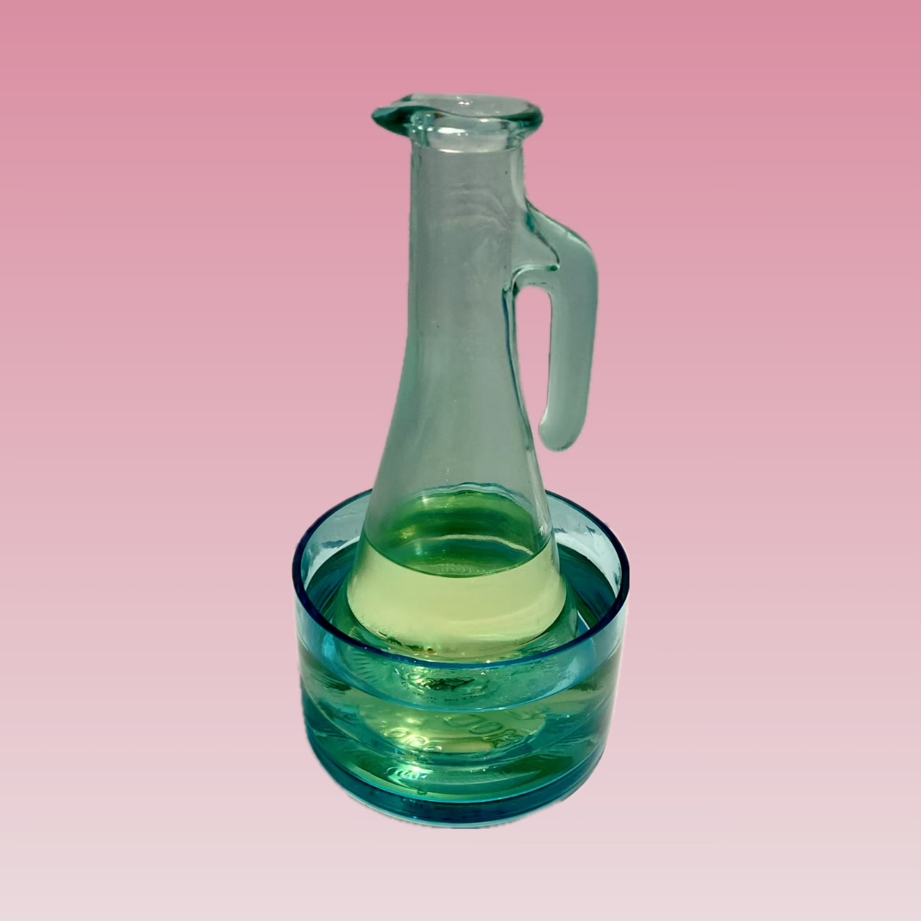 Fragrant massage oil warmed in a glass jug